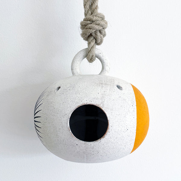Handmade ceramic birdhouse painted with sun and marigold dot  with hemp rope